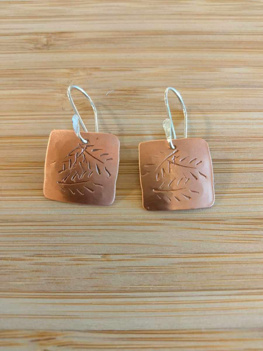 Square copper earrings with leaf motif
